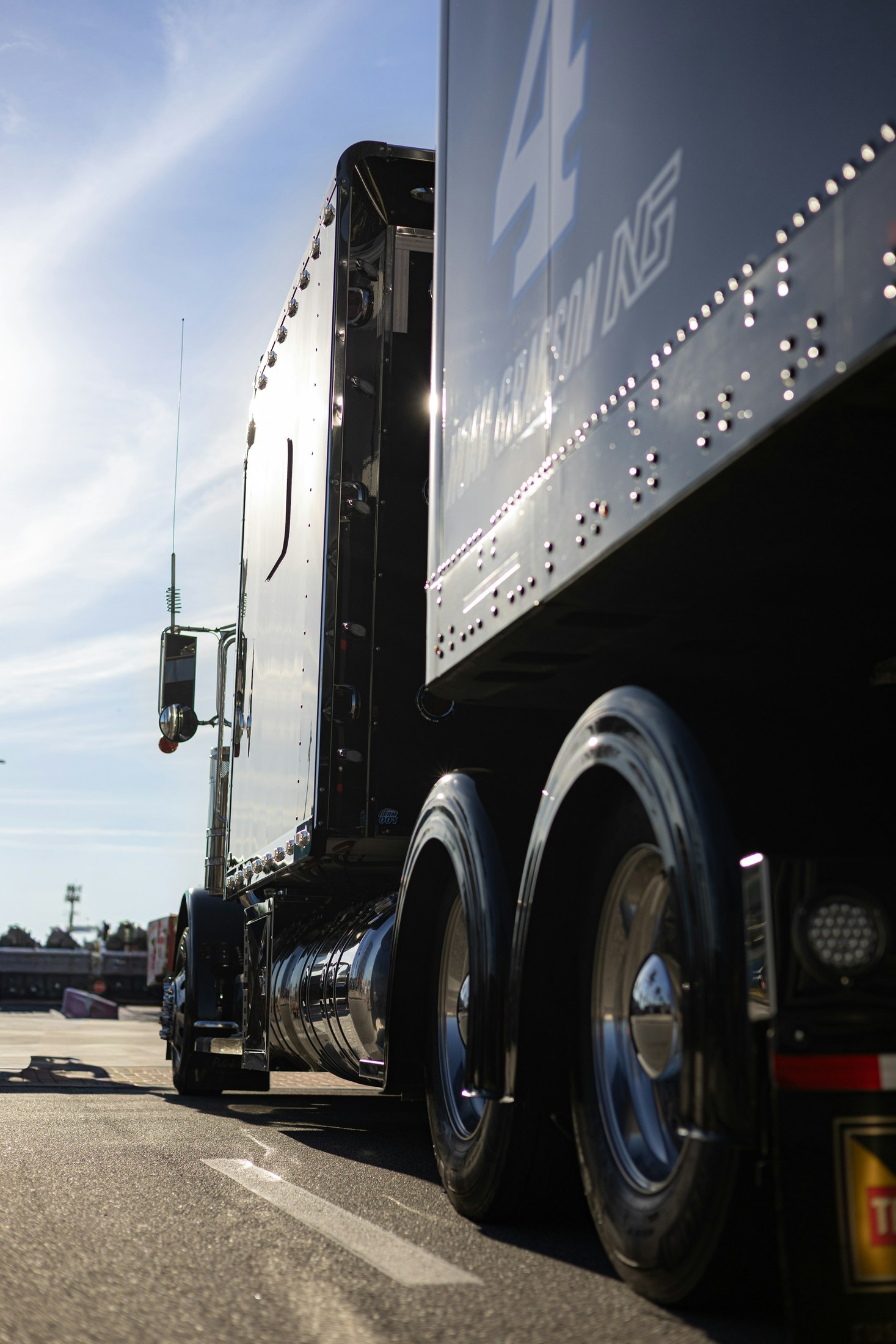 Close view of the side of a tractor and trailer with polished wheels